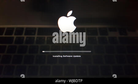 Update screen on apple MacBook laptop computer with progress bar ...