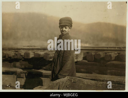 Harley Bruce. a young coupling-boy at tipple of Indian Mountain Mine, of Proctor Coal Co., near Jellico, Tenn. He appears to be 12 or 14 years old, and says he has been working there about a year. It is hard work and dangerous. Not many young boys employed in or about the mines of this region. Abstract: Photographs from the records of the National Child Labor Committee (U.S.) Stock Photo