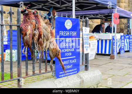 Local pheasants for sale at Hexham Farmers' Market, Northumberland, England, UK, which is held twice a month. Stock Photo