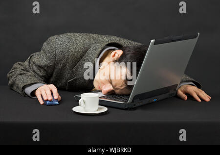 The guy worked at night in the Internet, was tired and has fallen asleep Stock Photo