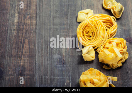 Fresh pasta on wooden table Stock Photo