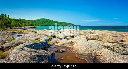 Scenic Landscape of the Volcanic Rock on the beautiful Rocky Coast of Lake Superior at at Neys Provincial Park, Ontario, Canada Stock Photo