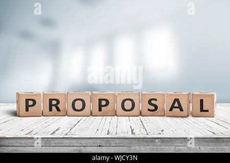 Proposal sign on a wooden desk in a bright office indicating a business suggestion Stock Photo