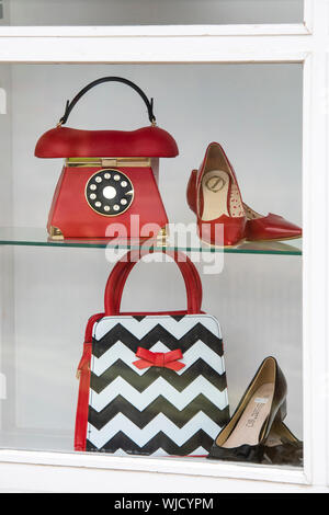 Vintage style ladies shoes and handbags in a shop window. Bourton on the Water, Cotswolds, Gloucestershire, England Stock Photo