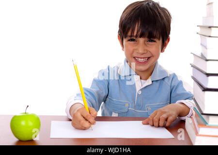 Young kid enjoying art as he draws on blank sheet of paper Stock Photo