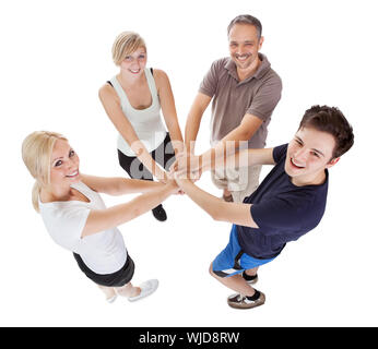 High angle view of a happy family with a teenage son and daughter holding hands Stock Photo