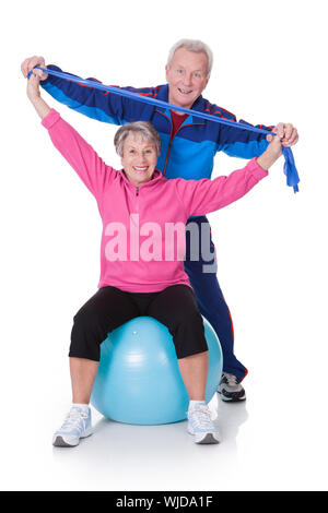 Portrait Of A Senior Couple Exercising On White Background Stock Photo
