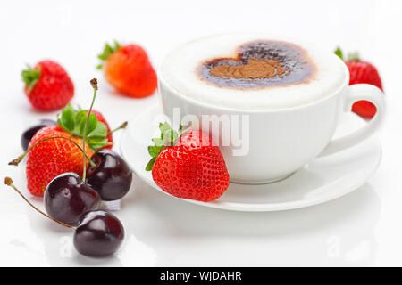 cappuccino in a cup in the shape of hearts,cherry  and strawberries isolated on white Stock Photo