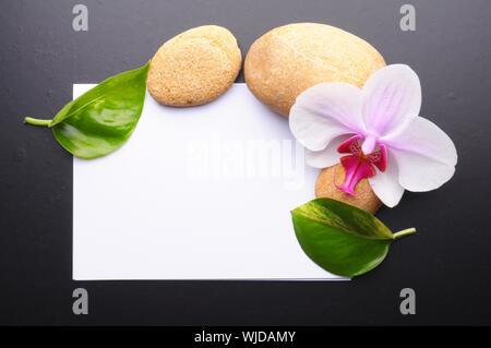 zen or spa stones with blank and empty copyspace paper Stock Photo