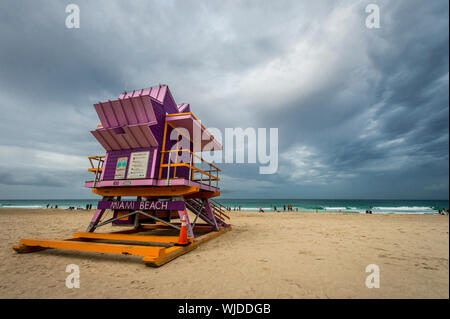 MIAMI - SEPTEMBER 02, 2019: Surfers take advantage of storm swells from Hurricane Dorian in front of a lifeguard tower on Labor Day at South Beach. Stock Photo