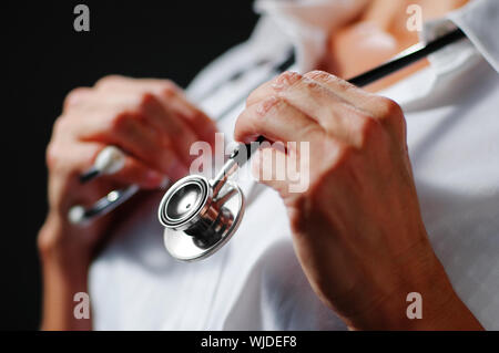 Close up of stethoscope being held by older womans hands. Stock Photo