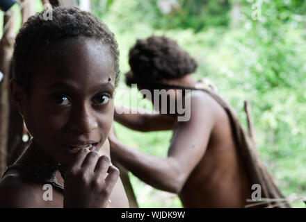 INDONESIA, NEW GUINEA, IRIAN JAYA, ONNI VILLAGE - JUNE 24: Portrait of Korowai girl  in the traditional wooden house built on a tree. New Guinea Islan Stock Photo