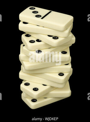 Tower from dominoes bones on a black background Stock Photo