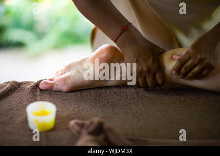 Therapist making spa reflexology foot massage Stock Photo