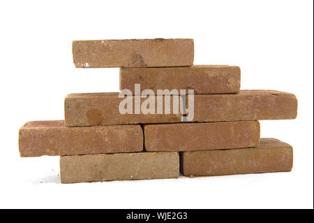 Building a wall with many bricks isolated over white Stock Photo