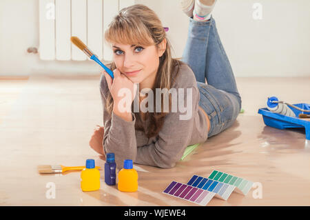 female paintier on floor Stock Photo
