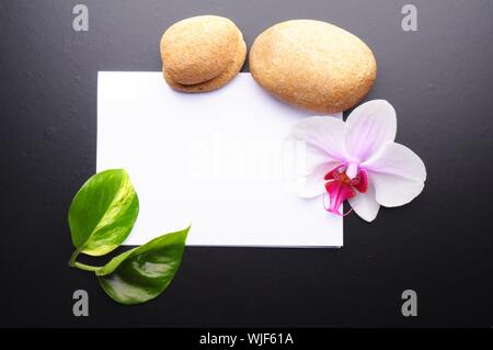 zen or spa stones with blank and empty copyspace paper Stock Photo