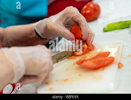 Evelyn Schwedock chops tomatoes as the group of senior citizens makes vegetable soup Wednesday, June 12, 2019 at Brandywine Living at Dresher Estates Stock Photo