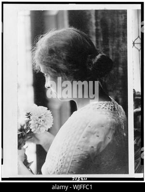 Helen Keller, head-and-shoulders portrait, facing left, holding flowers Stock Photo