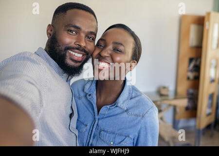 Smiling young African American couple taking a selfie at home Stock Photo