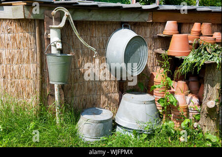Old water pump with sink bucket and tubs Stock Photo