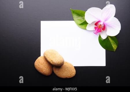 zen or spa stones with blank and empty copyspace paper Stock Photo