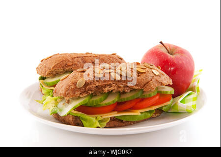 Healthy lunch with brown wholemeal bread roll with cereals and vegetables Stock Photo