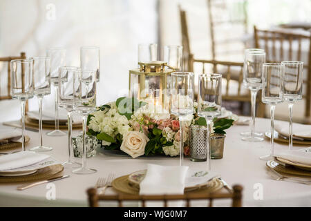 Table set up for wedding reception in tent Stock Photo