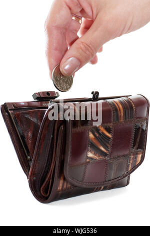 A female hand put into purse a coin isolated over white background Stock Photo