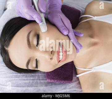 Cute Korean woman gets a face peeling procedure in a beauty salon. Skin care Stock Photo