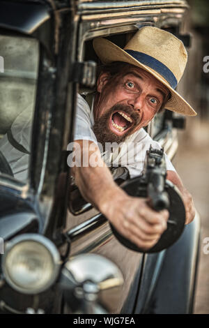 One retro 1920s gangster shooting machine gun Stock Photo