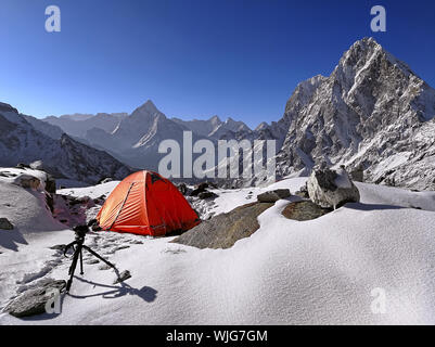 Tent camp with spectacular view of Himalayan peaks Ama Dablam (6812 m) and Cholatse (6501m) in Nepal, Himalayas. Travel and tourism concept Stock Photo