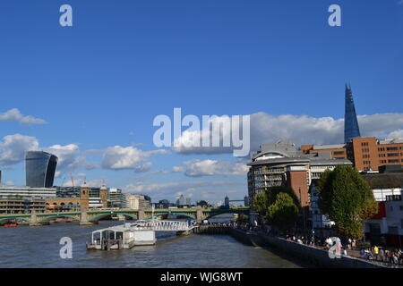 London/UK - August 31, 2014: Beautiful panoramic view to the Thames river, City of London, London bridge, the Shard and embankment on blue sunny sky. Stock Photo