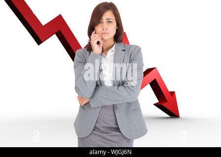 Upset thinking businesswoman against red arrow pointing down Stock Photo