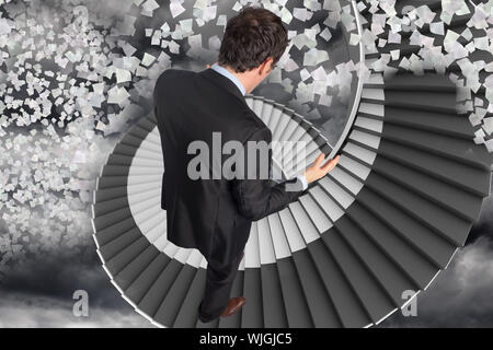 Stressed businessman gesturing against winding staircase in the sky with flying papers Stock Photo