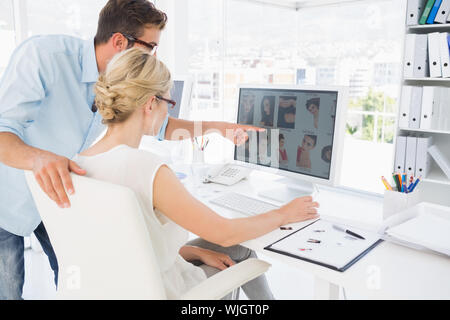 Side view of photo editors working on computer in a bright office Stock Photo