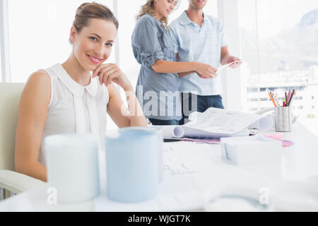 Group of artists working on designs in a bright office Stock Photo