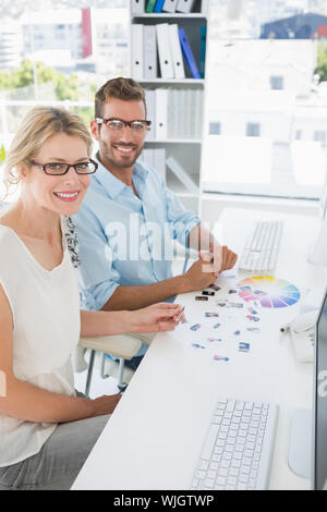 Side view portrait of photo editors working on computers in a bright office Stock Photo