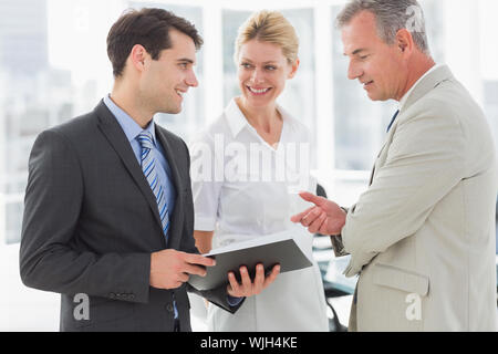 Smiling business team going over documents in the office Stock Photo