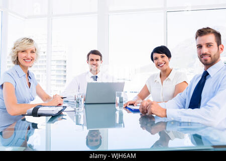 Smartly dressed young executives sitting around conference table in office Stock Photo