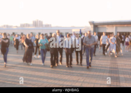 Crowd of people walking on the busy city street. Blured Stock Photo