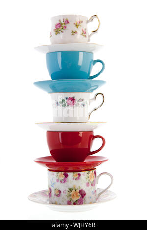 stacked vintage coffee or tea cups isolated over white background Stock Photo