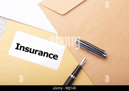 insurance concept with envelope showing risk concept Stock Photo - Alamy