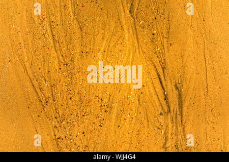 Close-up of sand with tidal ways and shells on the beach, full frame texture Stock Photo