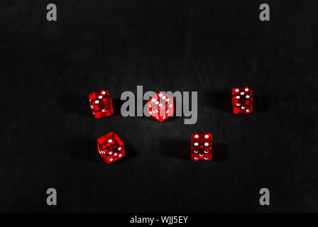 red dices on black carpet background Stock Photo