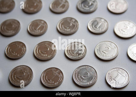 Ukrainian coins pattern of one hryvnia and two hryvnias value on white background Stock Photo