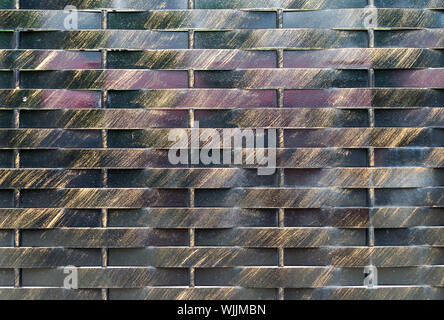 Old black and brown  metal wall background. Horisontal and vertical lines gate. City or rural rtexture. Dark geometric wallpaper Stock Photo