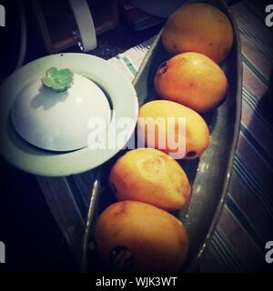 High Angle View Of Mangoes In Container On Table