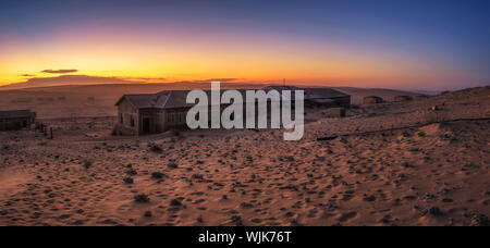 Sunrise above the abandoned houses of Kolmanskop ghost town, Namibia. Stock Photo