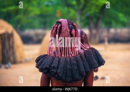 Traditional hairstyle of women in the Himba tribe photographed from behind Stock Photo